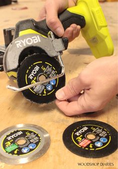 a person using a circular saw to cut holes in some material on a wooden table