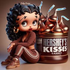 a doll sitting next to a can of hershey's kisses candy