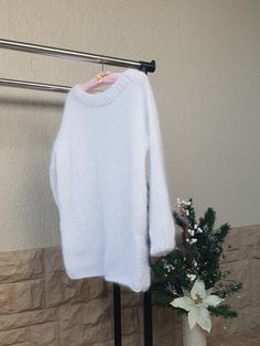 Fluffy mohair sweater is elegant and stylish. It is cozy and fluffy. It is also a great idea for a gift.  The material of this sweater consists of 50% mohair and 50% acrylic.  The sweater is loose fit.  Measurements of the sweater: XS-S: hips - 49 cm, pit to pit - 59 cm, length - 75 cm M-L: hips - 53 cm, pit to pit - 63 cm, length - 75 cm Xl: hips - 57 cm, pit to pit - 67 cm, length - 75 cm XXl: hips - 62 cm, pit to pit - 72 cm, length - 75 cm As it is handknitted measurements can differ for 1-2 Winter Mohair Sweater With Soft Knit, White Mohair Sweater With Crew Neck, White Mohair Crew Neck Sweater, Cozy Mohair Sweater For Winter, Chunky Knit Mohair Sweater With Long Sleeves, Long Sleeve Mohair Sweater With Chunky Knit, Mohair Long Sleeve Chunky Knit Sweater, Cozy White Long Sleeve Knitting Pattern, White Knitted Alpaca Sweater