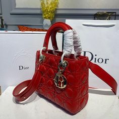 Description CHRSTN DR Small Lady DYOR Bag Red Patent Gold toned hardware For Women 8in/20cm CD Rep 1:1 Measurements: 20 x 16.5 x 9 cm / 8 x 6.5 x 3.5 inches The Lady DYOR handbag epitomizes the House’s vision of elegance and beauty. Refined and sleek, the timeless creation is crafted in blush and covered with Cannage stitching, creating an instantly recognizable quilted texture. The pale gold-finish metal ‘D.I.O.R.’ charms embellish and illuminate its silhouette. Featuring a removable shoulder s Lady Dior Handbag, Small Lady, Dior Handbags, Luxury Products, Pale Gold, Evening Clutch Bag, The Lady, Lady Dior Bag, Lady Dior