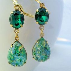 "These gorgeous earrings feature vintage glass opals and genuine Swarovski emerald colored rhinestones. The teardrop opals sparkle in shades of green, blue, gold and silver and measure 18x13mm (3/4\" x 1/2\") with a total drop of 51mm (2\"). I have handset the stones in gold plated prong settings and hung them from gold plated surgical steel, hypo-allergenic gold ear wire Please note: Each opal stone is unique, while all have the same beautiful colors each one displays a different pattern. I do Green Jeweled Teardrop Earrings, Green Pear-shaped Earrings For Party, Green Jeweled Teardrop Jewelry, Green Crystal Teardrop Earrings, Green Teardrop Crystal Earrings, Green Jewel Earrings For Gift, Pear-shaped Emerald Green Earrings, Green Jeweled Crystal Drop Earrings, Green Crystal Earrings With Gemstone