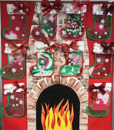 a fireplace decorated with christmas stockings and snowflakes