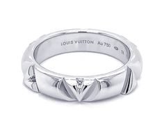 The LV Volt ring in 18-karat white gold is part of the LV Volt collection for men and women, a tribute to the energy of the iconic LV initials. The two letters split apart and repeat at regular intervals, generating a smooth tempo. Hallmarked "Louis Vuitton" and stamped "Au750" on the inside of the ring. The ring is EU size 58, US size 8.5. The total weight is 10.3 grams.This is a pre-owned ring in excellent condition. Item Specifications: Brand: Louis Vuitton Collection: LV Volt Metal: 18K Whit Luxury Engraved Ring For Anniversary, Luxury Silver Engraved Ring For Formal Occasion, Designer Rings With Polished Finish For Anniversary, Luxury Sterling Silver Engraved Diamond Cut Ring, Designer Hallmarked White Gold Rings, Designer White Gold Rings Hallmarked, Designer White Gold Hallmarked Rings, Luxury Sterling Silver Engraved Ring With Brilliant Cut, Luxury Silver Engraved Ring With Diamond Cut