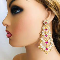 Beautiful and Unique Style Affordable Luxury traditional Bollywood Chandbali earrings with Kundan stones and Colored ruby semi precious Stones. 22k gold plated jewelry Length: Approx. 3 Inches Click here to see the complete collection of Kundan and Polki Statement Earrings at AryaFashions: https://www.etsy.com/shop/AryaFashions?section_id=25872820 Follow us on social media for new and latest designs: Facebook: www.facebook.com/shoparyafashions Pinterest: www.pinterest.com/aryafashions Instagram: Bollywood Style Meenakari Danglers For Reception, Kundan Chandbali Bridal Earrings For Reception, Kundan Temple Jewelry Danglers For Reception, Kundan Cutdana Danglers For Reception, Reception Chandbali Chandelier Earrings In Kundan, Reception Kundan Danglers With Cutdana Details, Temple Jewelry Meenakari Chandelier Earrings For Reception, Temple Style Kundan Bridal Earrings For Reception, Kundan Meenakari Chandbalis For Reception