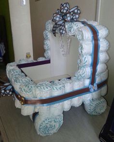 a large mirror made out of diapers with a bow on the front and side