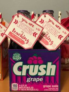 four bottles of crush grape soda on a table