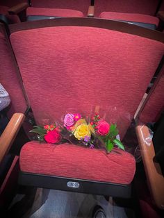 flowers are placed in the middle of an empty seat