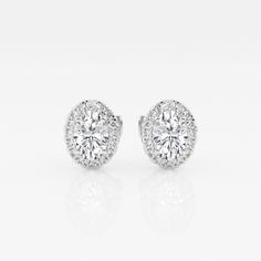 These imperial looking oval stud earrings are one of our best sellers. Large oval cut lab grown diamonds with a halo of round diamonds are a true amalgamation of style and glamor. Timeless Oval Brilliant Cut Earrings, Elegant Oval Diamond Earrings With Halo Setting, Oval Halo Diamond Earrings, Oval Halo Setting Earrings For Formal Occasions, Formal Oval Halo Setting Earrings, Formal Oval Earrings With Halo Setting, Elegant Oval Diamond White Diamond Earrings, Timeless Oval Diamond Earrings For Wedding, Timeless Oval Cubic Zirconia Diamond Earrings