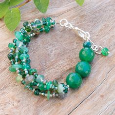 Does your spirit shine with a harmonious, cautious and tender aura? Then Nareerat's newest design is made for you and your gentle essence! Working with sterling silver-plated accessories, the Thai artisan crafts this bewitching strand beaded bracelet, whose superb look is composed of chalcedony and glass beads in refreshing green hues, arranged on a silk thread that displays the gem's energy of thoughtfulness. Elegant Green Faceted Beaded Bracelets, Green Glass Bracelets With Faceted Beads, Green Multi-strand Beads For Jewelry Making, Green Multi-strand Jewelry With Colorful Beads, Green Multi-strand Beaded Bracelets With Faceted Beads, Thailand Gifts, Green Hues, Beaded Crafts, Strand Bracelet