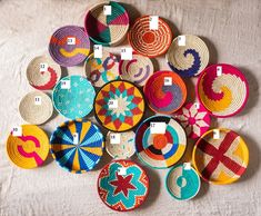 many colorful baskets are arranged on a white tablecloth and one has a star in the middle