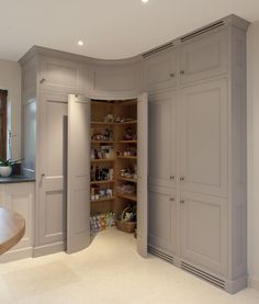 an open closet in the middle of a room with a sink and countertop area