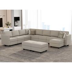 a living room with a sectional couch and ottoman