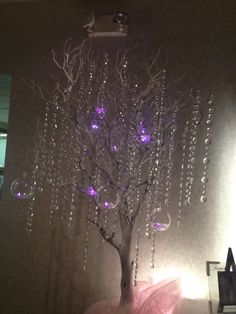 a white tree with purple lights on it