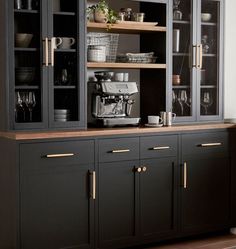 a kitchen with black cabinets and gold trim on the doors is pictured in this image