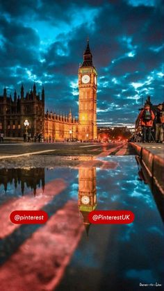 the big ben clock tower towering over the city of london at night with its reflection in the water