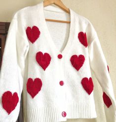 Unique Cardigan with Red Hearts,Cozy Knit Top, Soft Women Sweater, Women Knit Outfit,Gift kit for her, V neck button up, Y2K Soft Girl Style This cardigan is a UNIQUE and one and only piece. It is handknitted with mixture of cotton and polyester yarn. (%70 Cotton, %30 Polyester) Chunky Cherry Pattern is created with Punch Needle Technique and %100 baby cotton yarn is used. 100% Handmade, Free Shipping SIZE: One size fits for 34,36,38,40,42 // XS,S,M,L One size measurements: Shoulder: 62 CM Bust: Cute White Sweater With Buttons, White Sweater For Valentine's Day, White Long Sleeve Sweater For Valentine's Day, White Knit Sweater With Red Mini Hearts, Cute Red Long Sleeve Cardigan, Knit Sweater With Heart Print For Winter, Heart-shaped Knit Sweater For Winter, Y2k Soft Girl, Y2k Soft