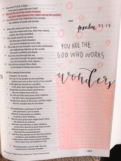 an open bible with pink and black writing on the page, which reads you are the god who works wonders