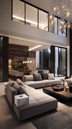 a living room with couches, tables and lamps in the middle of it's floor to ceiling windows