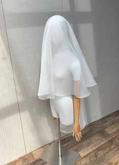 a mannequin's head is covered with a white cloth