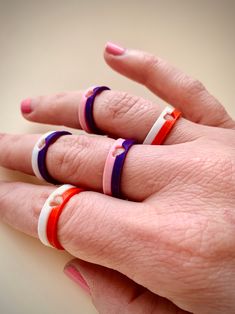 a woman's hand with three rings on it