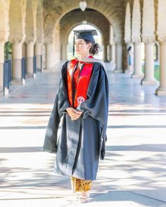 a woman in a graduation gown and cap