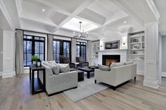 a living room filled with furniture and a fire place in the middle of a room