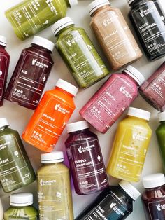 many different types of juices are arranged together