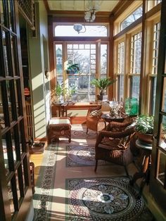 the sun shines through an open window into a room filled with furniture and potted plants