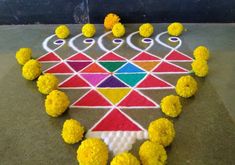 this is an image of a colorful design on the ground with yellow flowers around it