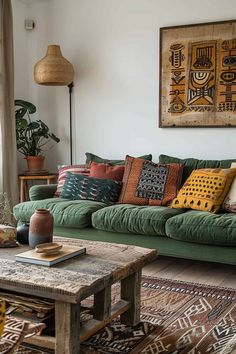 a living room with green couches and colorful pillows on the sofa, in front of a large window