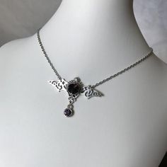 This gothic vampire inspired necklace is made with an antiqued silver plated filigree bat and findings, accented with sparkling glass crystals in DEEP VIOLET PURPLE. Wingspan is 2 1/4" wide and centerpiece is 1 1/2" tall in the center.necklace isadjustable 15-18" with a lobster clasp and chain extender in the back. If you would like a different length or stone color, please send us a message. Matching headpiece is available in our store. Goth Jewelry Violet Vixen, Silver Vampire Style Necklace, Gothic Nickel-free Necklace For Halloween, Gothic Nickel-free Necklaces For Halloween, Gothic Pendant Necklace For Halloween, Halloween Gothic Pendant Necklace, Gothic Metal Jewelry For Fantasy Events, Halloween Gothic Pendant Jewelry, Silver Gothic Necklaces For Fantasy Events