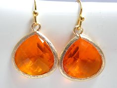 Stunning glass gold earrings in orange color! These beautiful glass faceted framed stones are suspended from gold plated ear wires. Absolutely gorgeous! Glass bead: 16mm*16mm Earrings measure 33mm including the ear wire MORE COLORS AVAILABLE IN MY SHOP! UPGRADE TO GOLD FILLED EAR WIRE FOR AN ADDITIONAL FEE. ALSO AVAILABLE IN SILVER AS SEEN IN THE LAST PICTURE: https://www.etsy.com/listing/103160164/orange-earrings-silver-earrings-silver?ga_search_query=orange Visit my shop at http://www.etsy.com Nickel Free Orange Jewelry For Party, Nickel Free Orange Earrings For Party, Orange Teardrop Earrings As Gift, Orange Teardrop Earrings For Party, Nickel-free Orange Jewelry For Party, Elegant Orange Drop Earrings, Cheap Unique Orange Earrings, Nickel-free Orange Earrings For Party, Cheap Vintage Orange Earrings