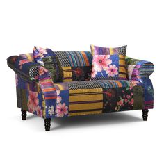 a patchwork couch with colorful pillows on it's back and arms, sitting in front of a white background