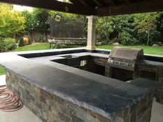 an outdoor bbq with grill built into it