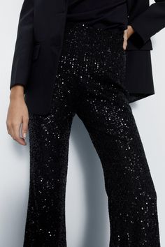 All-over sequin embellishments add glamorous texture 
 Flared silhouette from knee to hem creates an elongating shape 
 High-waisted fit with tonal stitching for a streamlined look 
Make a dazzling entrance in these scene-stealing sequin pants. The allover shimmering embellishments demand attention, while the flared leg creates an elongating silhouette. Pair with a fitted blazer and strappy heels for cocktail parties and nights out dancing. For drinks with friends, match with a silky camisole and wedges. The high-waisted fit creates a polished, put-together aesthetic. With their standout texture and flattering shape, these pants ensure all eyes will be on you for all the right reasons. Silky Camisole, Sequin Flare Pants, Girls Occasion Dresses, Sequin Pants, Christening Outfit, Tall Dresses, Black Tie Dress, Party Skirt, Cocktail Parties