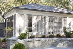 a white gazebo sitting on top of a stone wall