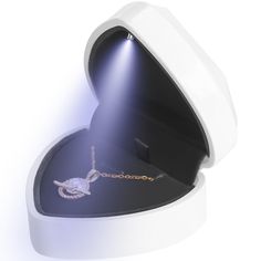 a white heart shaped box with a chain in it's center and lights on the inside