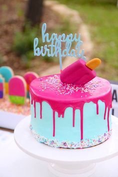 a birthday cake decorated with pink and blue icing