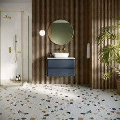 a bathroom with a sink, mirror and plants in the corner on the wall next to it