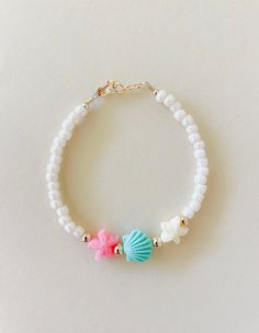 I grew up playing on the Oregon coast. This bracelet brings me back to then! Any of my coastal lovers will love this bracelet. Cream shinny beads with starfish and seashells beads! Made with hypoallergenic gold filled attachments. You will love this one! Starfish Beaded Bracelet, Ocean Themed Beaded Bracelets, Mermaid Beaded Bracelet, Beach Beads Bracelets, Coastal Granddaughter Bracelets, Coastal Bracelet Ideas, Sea Beads Bracelet, Colorful Beads Starfish Bracelet For Beach, Gold Beaded Beachy Bracelets