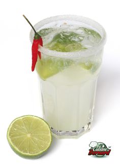 a limeade cocktail with a red chili pepper on the rim