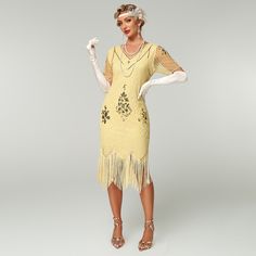 The Sequin Short Sleeves Fringe Flapper Dress combines vintage charm with modern sparkle, featuring shimmering sequins and classic short sleeves. The fringe detailing adds playful movement, evoking the glamour of the Roaring Twenties. Perfect for themed parties and special nights out, this dress is sure to make a statement. Vintage Beaded Fringe Flapper Dress, Flapper Dresses With Beaded Fringe For Party Season, Festive Short Sleeve Sequin Dress, Glamorous Fringe Dress For Costume Party, Fitted Sequin Dress With Fringe For Summer, Vintage Short Sleeve Dress For Costume Party, Vintage Fringe Flapper Dress, Fitted Fringe Flapper Dress For Costume Party, Vintage Knee-length Flapper Party Dress