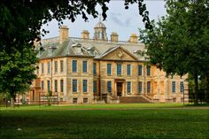 a large building with many windows in the middle of it's front lawn area