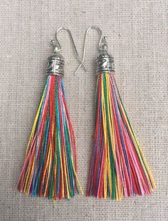 Chic multi color tassel earrings!  They would add a pop of color to any outfit for any occasion.  Dress them up or down.  They are timeless and versatile.  They are lightweight, fun and unique!The tassels measure 2 1/8” long by 1/4” wide.  They hang from simple silver ear wire hooks.  Overall drop length is about 2 1/4”.  Metal is allergy free plated silver.These are my latest creation!  I have them available in many colors!  Find them all under the category tassel earrings in my shop.Thanks for Rainbow Tassel Earrings For Gifts, Colorful Dangle Tassel Earrings Gift, Rainbow Dangle Tassel Earrings Gift, Rainbow Fringe Earrings As Gift, Multicolor Fringe Tassel Dangle Earrings, Rainbow Tassel Dangle Earrings, Multicolor Tassel Earrings As A Gift, Rainbow Dangle Tassel Earrings, Multicolor Fringe Dangle Earrings