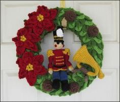 a wreath with a nutcracker and flowers on it