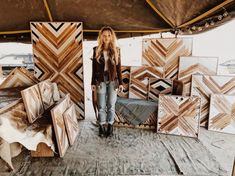 a woman standing in front of some wooden pieces