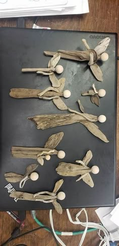 several pieces of driftwood sitting on top of a wooden table next to wires and cords