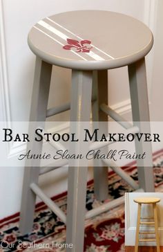 the bar stool makeover is painted white and has red flowers on it, along with an area rug