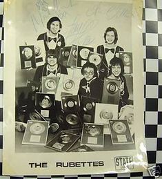 an old black and white photo of the rubberette's in front of a checkered wall