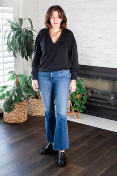 StyleDahlia wearing the classic combination of black sweater and jeans with loafers. #styledahlia #blacksweater #sweaterweather #winterstyle #casualstyle #loafers #over40style Loafers And Flare Jeans, Black Sweater And Jeans, Jeans With Loafers, Sweater And Jeans, Loafers Outfit